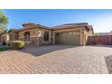 Home exterior with paver driveway and three-car garage at 2299 E Saddlebrook Rd, Gilbert, AZ 85298