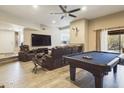 Open living area with a pool table, large TV, and comfortable leather furniture at 14679 N Love Ct, Fountain Hills, AZ 85268