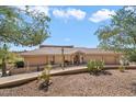 Single-story home with desert landscaping and large driveway at 11420 N Kiowa Cir, Fountain Hills, AZ 85268