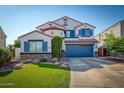 Two-story home with a blue garage door and landscaping at 775 E Leslie Ave, San Tan Valley, AZ 85140