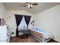 Small bedroom with a twin bed, desk, and built-in shelving at 775 E Leslie Ave, San Tan Valley, AZ 85140