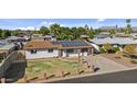 Property view showing a house with a yard and solar panels at 7428 E Carol Cir, Mesa, AZ 85208