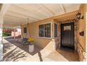 Covered porch with hanging bench and potted plants at 5745 N 13Th St, Phoenix, AZ 85014