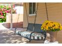 Relaxing porch swing with black frame and striped cushion at 5745 N 13Th St, Phoenix, AZ 85014