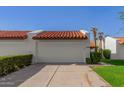 Front view of a Spanish style home with a two-car garage at 11846 N 93Rd St, Scottsdale, AZ 85260