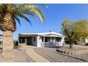 Single-wide manufactured home with carport and landscaped yard at 8304 E Desert Trl, Mesa, AZ 85208