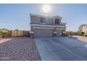 Two-story house with a three-car garage and desert landscaping at 1865 S 231St Ln, Buckeye, AZ 85326