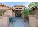 Front entry with walkway, landscaping, and security door at 13047 W Peach Blossom Dr, Sun City West, AZ 85375