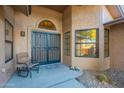 Front entry with security door and rocking chair at 13047 W Peach Blossom Dr, Sun City West, AZ 85375