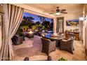 Covered patio with seating area, fire pit, and outdoor dining at 23228 N Gaviota Dr, Sun City West, AZ 85375