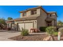 Two-story house with a two-car garage and desert landscaping at 6338 W Preston Ln, Phoenix, AZ 85043