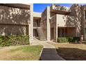 Front view of a two-story building with stairs and landscaping at 1920 W Lindner Ave # 137, Mesa, AZ 85202