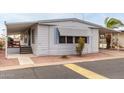 Side view of a manufactured home with steps and landscaping at 205 S Higley Rd # 288, Mesa, AZ 85206