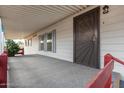 Covered porch with a security door leading into the home at 205 S Higley Rd # 288, Mesa, AZ 85206