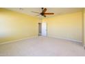 Spacious bedroom with neutral walls, ceiling fan and carpeted floor at 29408 N 244Th Dr, Wittmann, AZ 85361
