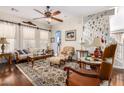 Living room with hardwood floors, fireplace, and decorative accents at 44163 W Palo Abeto Dr, Maricopa, AZ 85138