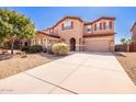 Two story house with tan exterior and landscaping at 44163 W Palo Abeto Dr, Maricopa, AZ 85138