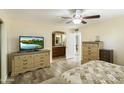 Bright bedroom with wood floors and built-in dresser at 11405 S Tawa Ln, Phoenix, AZ 85044