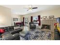 Spacious living room featuring a fireplace and comfortable seating at 11405 S Tawa Ln, Phoenix, AZ 85044