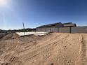 New home construction site with poured foundation and block wall at 47748 W Moeller Rd, Maricopa, AZ 85139