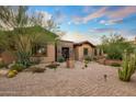 Spanish-style home with brick accents and landscaped desert front yard at 37440 N 104Th Pl, Scottsdale, AZ 85262