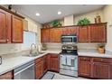 Corner kitchen with stainless steel appliances and wood cabinets at 3104 E Broadway Rd # 51, Mesa, AZ 85204