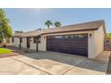 Single story home with dark brown garage door and newly paved driveway at 3609 E Ludlow Dr, Phoenix, AZ 85032