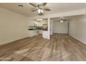 Open concept kitchen and dining area with white cabinets and wood-look floors at 4622 S 21St St, Phoenix, AZ 85040