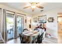 Charming dining area with a round table and access to the backyard at 13046 W Wildwood Dr, Sun City West, AZ 85375