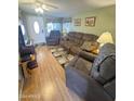 Bright living room featuring wood floors and comfy furniture at 1541 W Yurok Ave, Apache Junction, AZ 85119