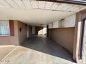 Covered carport with access to house and storage cabinets at 3542 E Earll Dr, Phoenix, AZ 85018