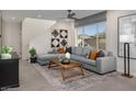 Spacious living room featuring a large sectional sofa and a wood coffee table at 9243 E Sector Dr, Mesa, AZ 85212