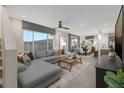 Open-concept living room with L-shaped sofa and dining area at 9243 E Sector Dr, Mesa, AZ 85212