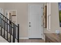Bright entryway with modern staircase and art at 9237 E Sector Dr, Mesa, AZ 85212