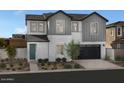 Two story home with gray siding and teal door at 9237 E Sector Dr, Mesa, AZ 85212