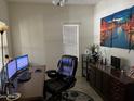 Bright home office featuring a large desk and comfortable chair at 2665 E Gillcrest Rd, Gilbert, AZ 85298