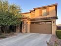 Two-story house with stone accents and a three-car garage at 2665 E Gillcrest Rd, Gilbert, AZ 85298