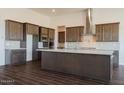 Spacious kitchen featuring dark wood cabinets and a large island at 3823 W Lodge Dr, Laveen, AZ 85339