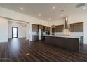 Open concept kitchen with an island, dark cabinets, and tile floors at 3823 W Lodge Dr, Laveen, AZ 85339