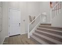 Elegant staircase with modern metal railing and carpeting at 9233 E Sector Dr, Mesa, AZ 85212