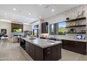 Gourmet kitchen featuring a large island, stainless steel appliances, and custom cabinetry at 10284 E Running Deer Trl, Scottsdale, AZ 85262