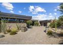 Modern desert home with paver driveway and drought-tolerant landscaping at 10284 E Running Deer Trl, Scottsdale, AZ 85262