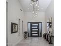 Bright and spacious entryway with tile floors and modern chandelier at 10284 E Running Deer Trl, Scottsdale, AZ 85262