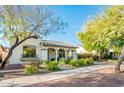 Charming one-story home with arched entryway and well-manicured landscaping at 20431 W Lost Creek Dr, Buckeye, AZ 85396