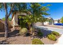 Landscaped front yard with mature trees at 1952 N 212Th Ln, Buckeye, AZ 85396