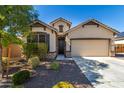 Single-story home with two-car garage and desert landscaping at 1952 N 212Th Ln, Buckeye, AZ 85396