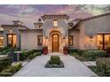 Elegant home entrance with a herringbone walkway and lush landscaping at 20567 N 112Th St, Scottsdale, AZ 85255