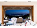 Living room with sliding doors opening to a patio, pool, and city views at 20567 N 112Th St, Scottsdale, AZ 85255