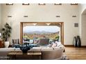 Spacious living room with large windows, mountain views, and hardwood floors at 20567 N 112Th St, Scottsdale, AZ 85255