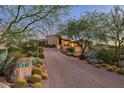 Luxury home with a long driveway and desert landscaping at 9719 E Madera Dr, Scottsdale, AZ 85262